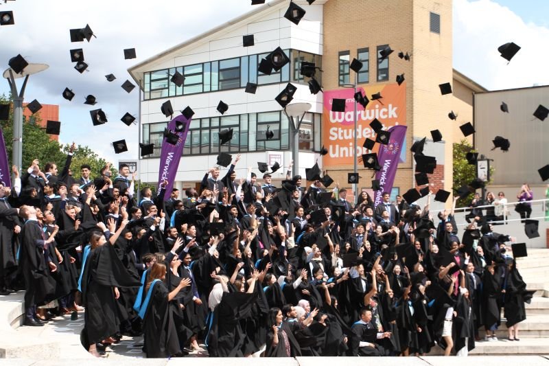 Promotional graphic for University of Warwick admissions with UK and Hong Kong focus, featuring campus and text on admissions, school information, and interview skills by Helios Education 華威大學入學推廣圖片,聚焦英國及香港,展示校園及入學介紹、學校資訊、面試技巧文字,由Helios Education提供 华威大学入学推广图片,聚焦英国及香港,展示校园及入学介绍、学校资讯、面试技巧文字,由Helios Education提供